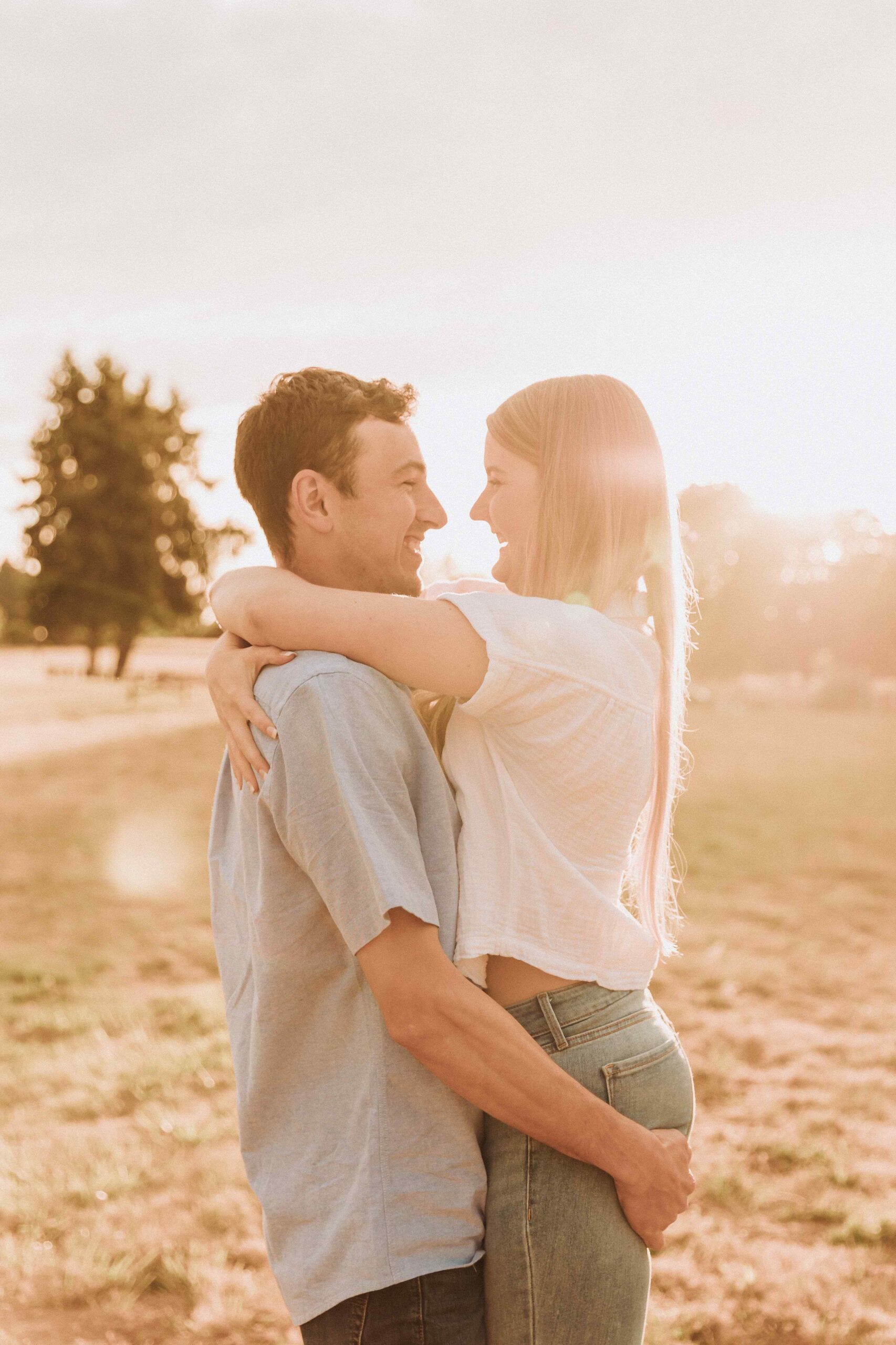 Couple taking engagement photos at Champoeg State Park in Oregon during golden hour