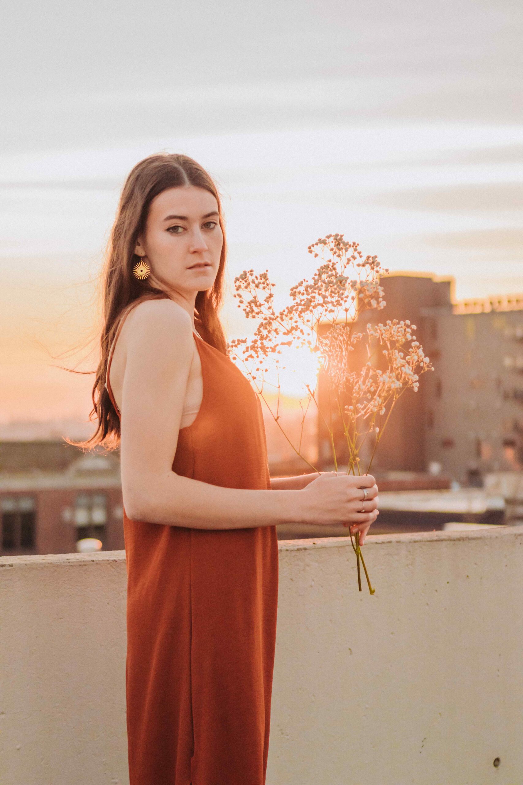 Portrait of woman holding flowers during sunset in Salem, Oregon.