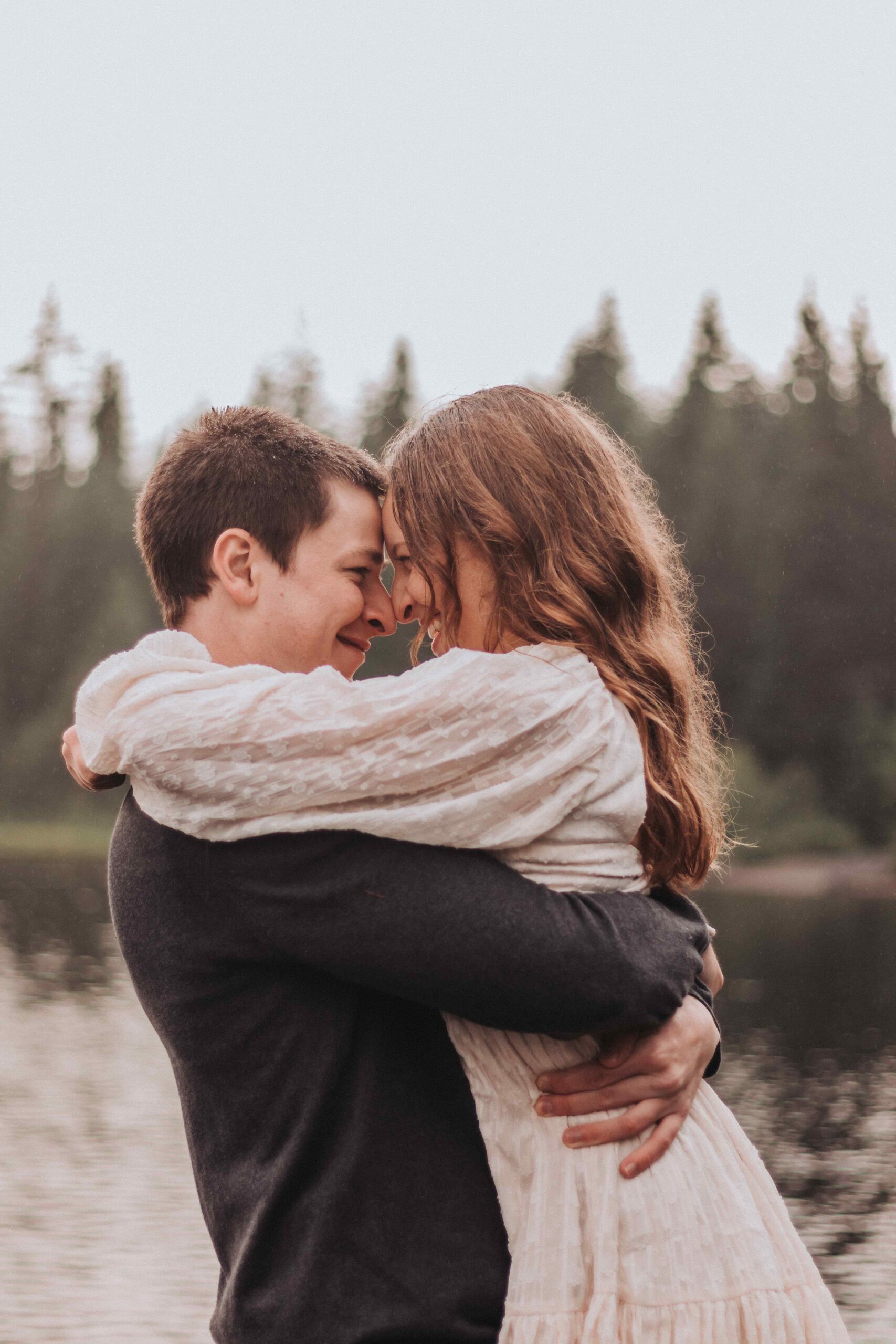 Couple taking engagement photos at Trillium Lake in Oregon